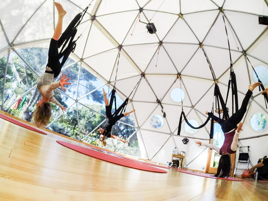 A Woman Does Yoga On The Terrace In A Geo Dome Glamping Tent